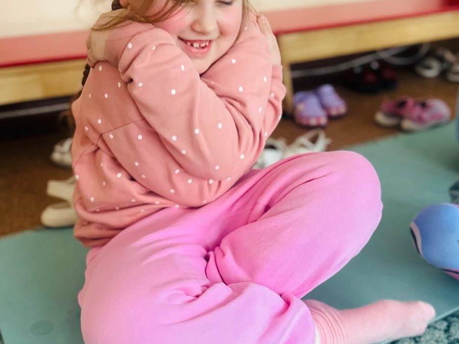 Mergaitė apkabina save ramybės pratimo metu